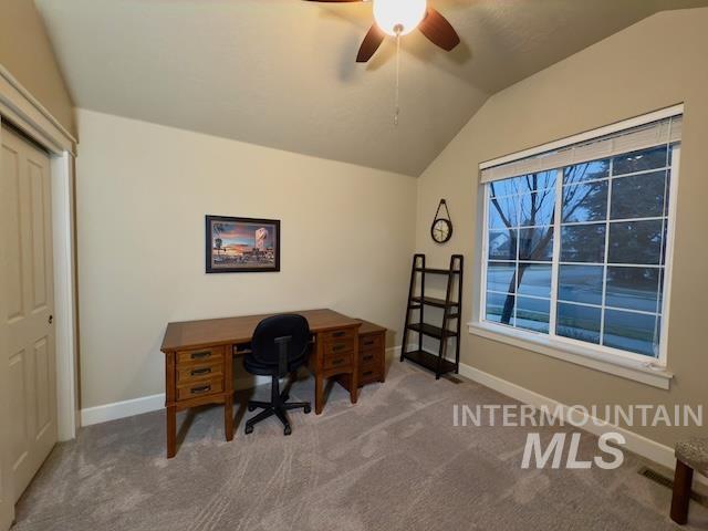 carpeted office space featuring lofted ceiling and ceiling fan