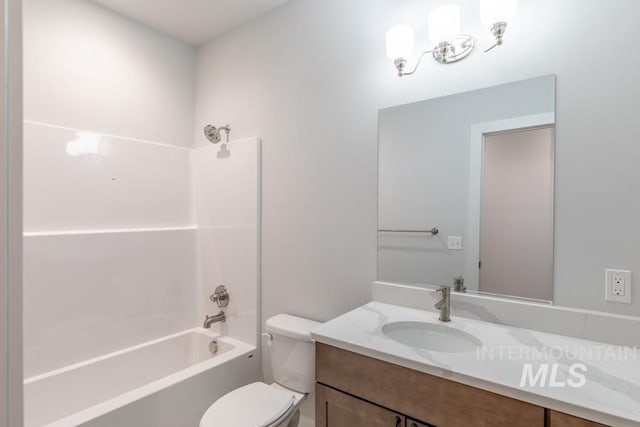 bathroom featuring vanity, toilet, and bathing tub / shower combination