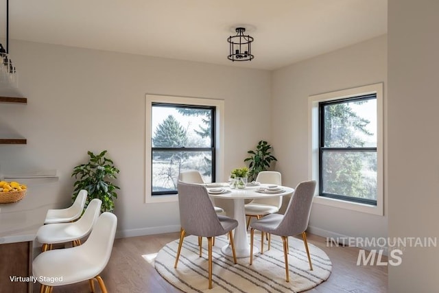 dining room with wood finished floors and baseboards