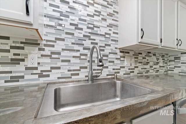 7267 Bowmont Rd, Nampa, ID 83686 - kitchen view of a sink, decorative backsplash, and white cabinets