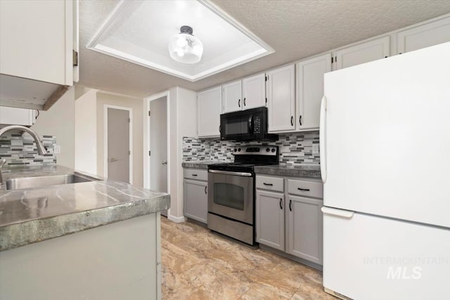 7267 Bowmont Rd, Nampa, ID 83686 - kitchen featuring freestanding refrigerator, stainless steel electric range, black microwave, a sink, and tasteful backsplash