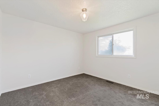 7267 Bowmont Rd, Nampa, ID 83686 - unfurnished room with dark colored carpet and baseboards
