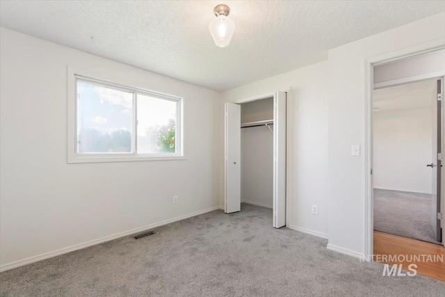 7267 Bowmont Rd, Nampa, ID 83686 - unfurnished bedroom with carpet flooring, a textured ceiling, baseboards, and a closet