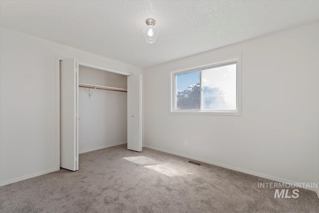 7267 Bowmont Rd, Nampa, ID 83686 - unfurnished bedroom featuring carpet floors, a closet, and baseboards