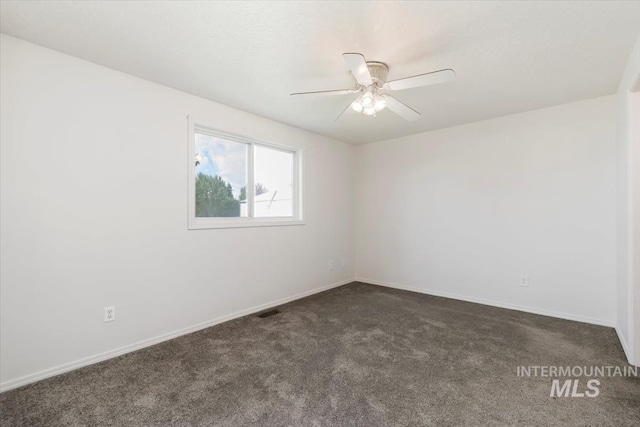 7267 Bowmont Rd, Nampa, ID 83686 - empty room with a ceiling fan, dark carpet, and baseboards