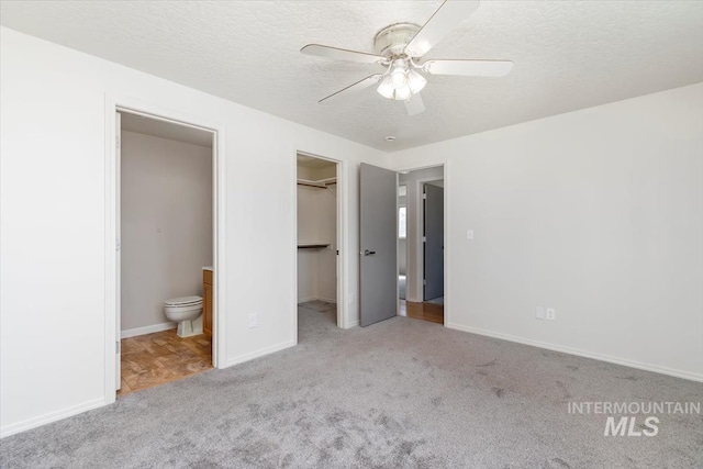 7267 Bowmont Rd, Nampa, ID 83686 - unfurnished bedroom featuring carpet, a textured ceiling, a spacious closet, ensuite bathroom, and baseboards