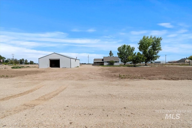 7267 Bowmont Rd, Nampa, ID 83686 - view of yard featuring a garage, dirt driveway, and an outbuilding