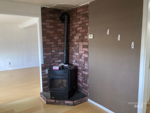 room details with wood-type flooring and a wood stove