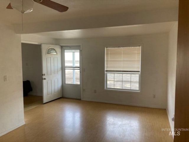 empty room with light hardwood / wood-style flooring and ceiling fan