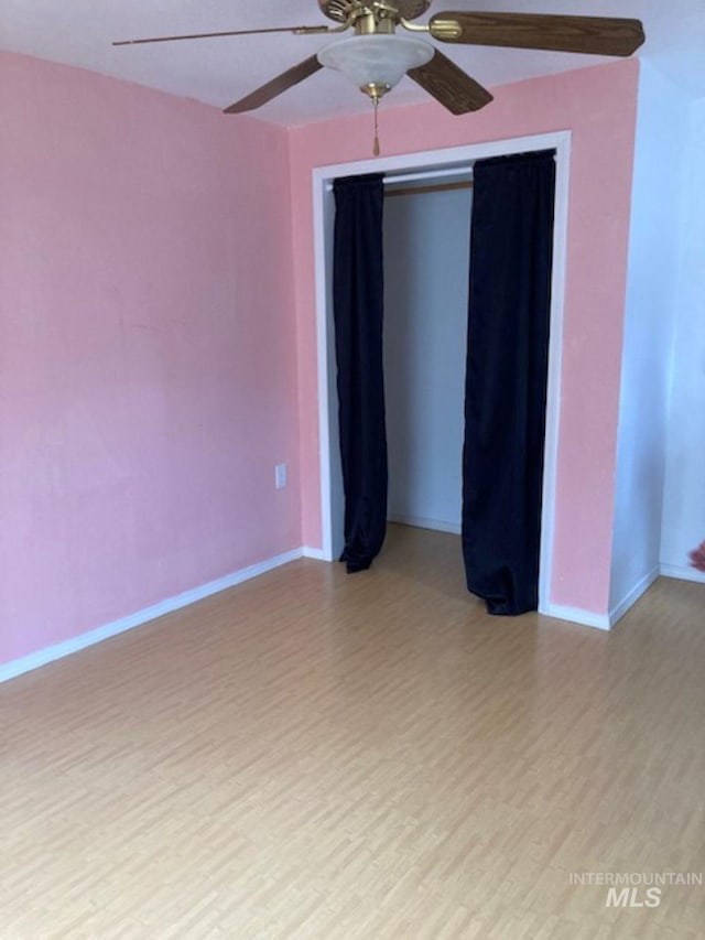 spare room featuring light hardwood / wood-style flooring and ceiling fan