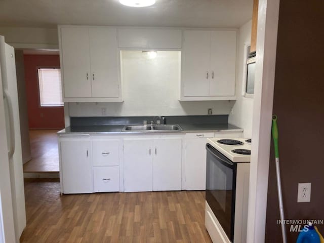 kitchen featuring white cabinetry, white appliances, sink, and light wood-type flooring