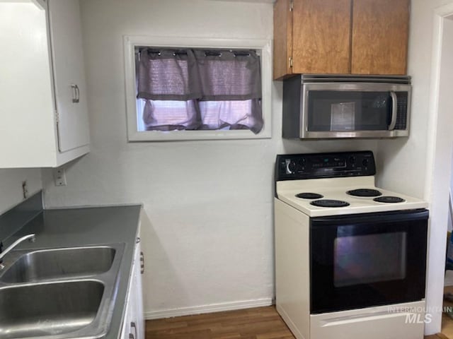 kitchen with range with electric cooktop, sink, and dark hardwood / wood-style flooring