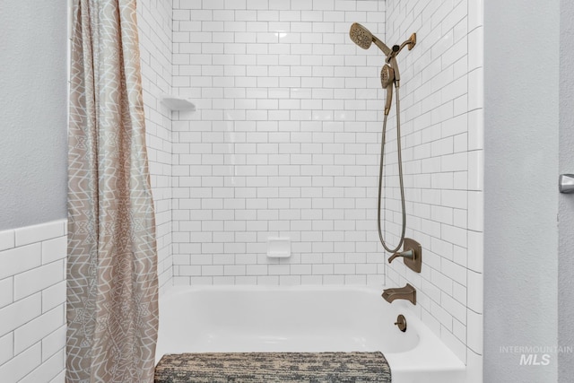 full bath featuring shower / bathtub combination with curtain and a textured wall