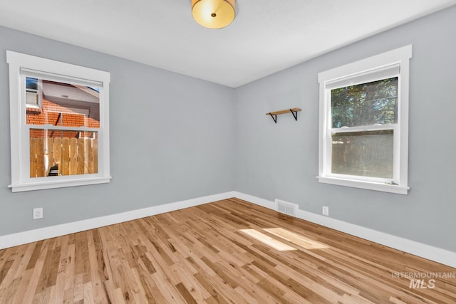 unfurnished room featuring wood finished floors and baseboards
