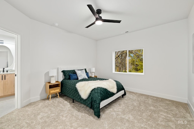 bedroom featuring ceiling fan, light colored carpet, a sink, visible vents, and baseboards