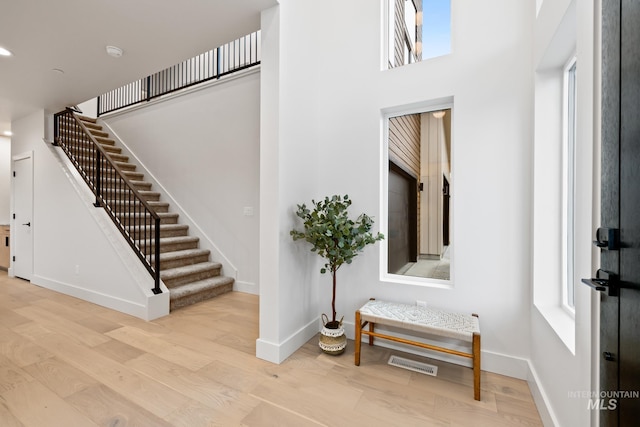 staircase with hardwood / wood-style floors