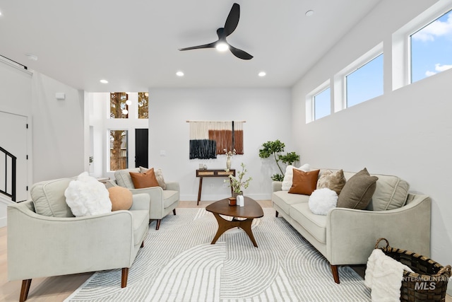 living room with ceiling fan and light wood-type flooring