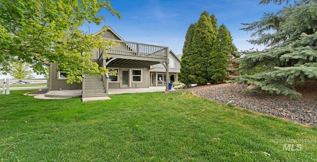 rear view of property with a patio, a yard, and a wooden deck