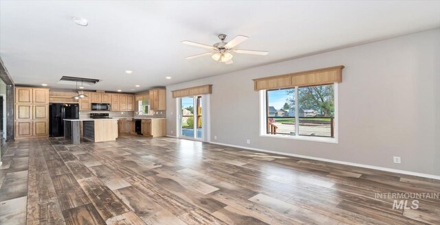 unfurnished living room with wood finished floors, baseboards, a ceiling fan, and recessed lighting