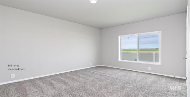 spare room with carpet flooring and baseboards
