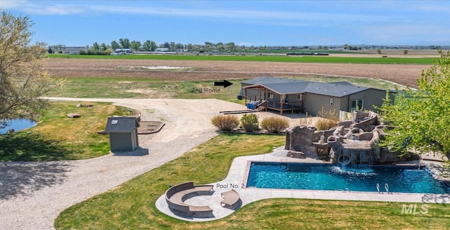 swimming pool with a rural view and a deck