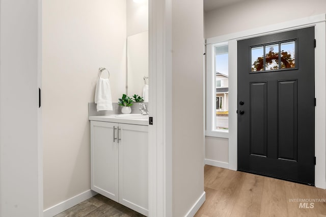 foyer featuring sink and light hardwood / wood-style flooring