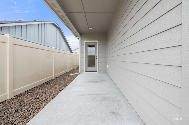 view of exterior entry featuring a patio area