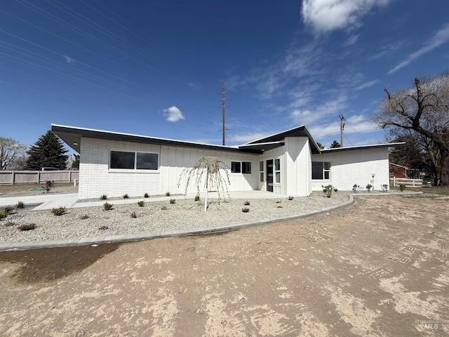 view of front of property with fence and brick siding
