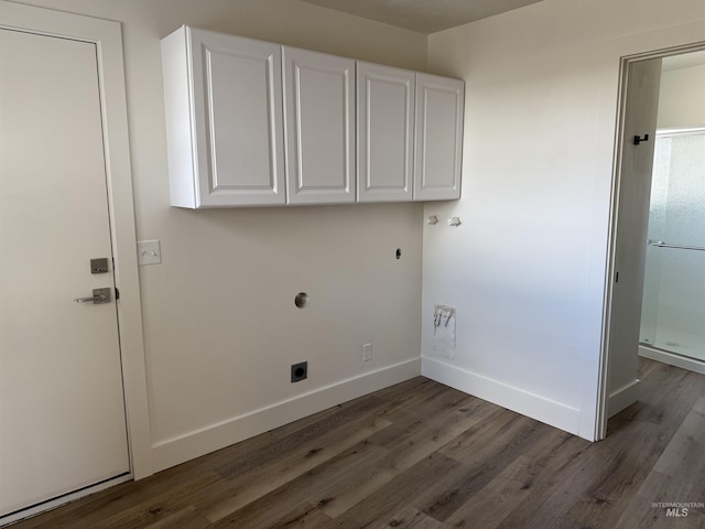 laundry area with cabinet space, electric dryer hookup, baseboards, and wood finished floors