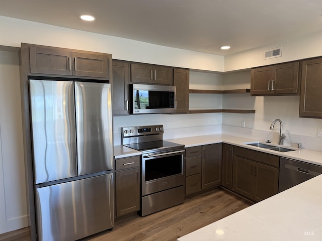 kitchen with a sink, light countertops, stainless steel appliances, and visible vents