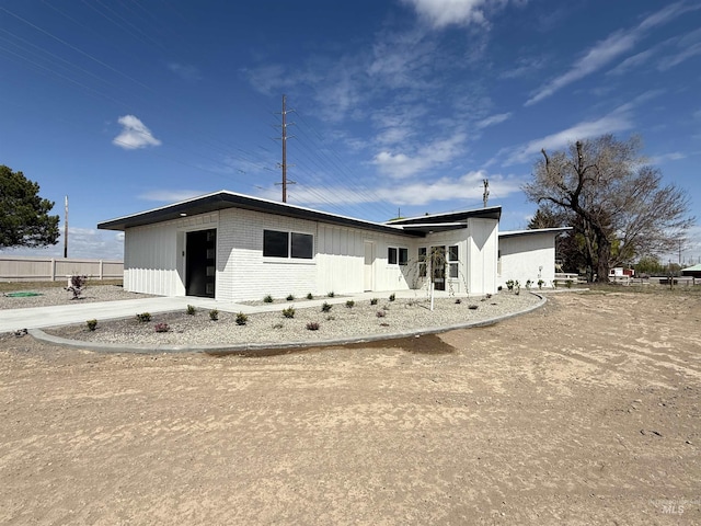 view of front of property with fence and brick siding