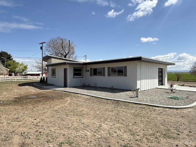 back of property with fence and brick siding