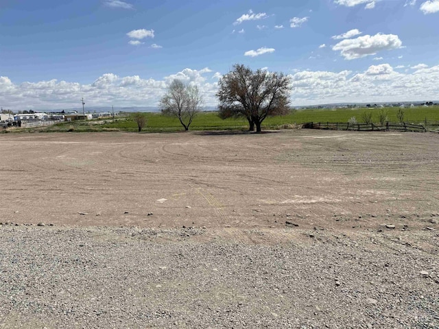 view of yard featuring fence and a rural view