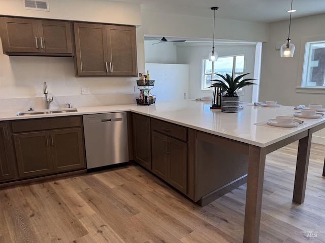 kitchen with a sink, a peninsula, light countertops, a ceiling fan, and dishwasher