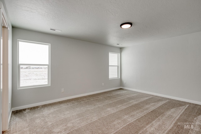 8246 E Bright Angel Dr, Nampa, ID 83687 - carpeted spare room with a textured ceiling, visible vents, and baseboards