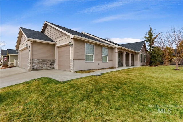 view of front of house with stone siding, a front lawn, an attached garage, and driveway