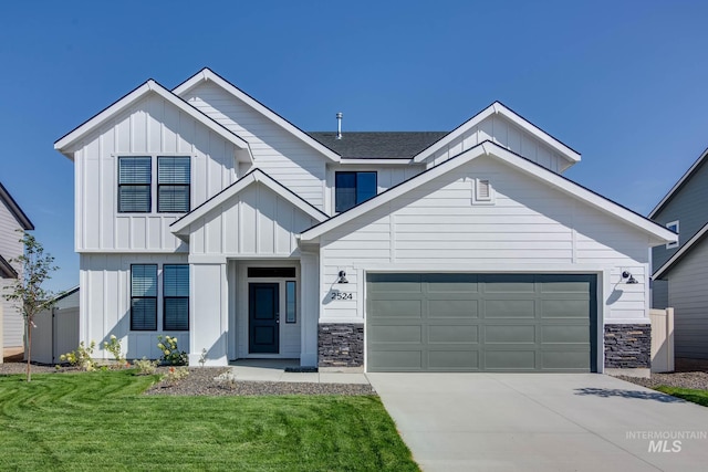 view of front of home with a front yard and a garage