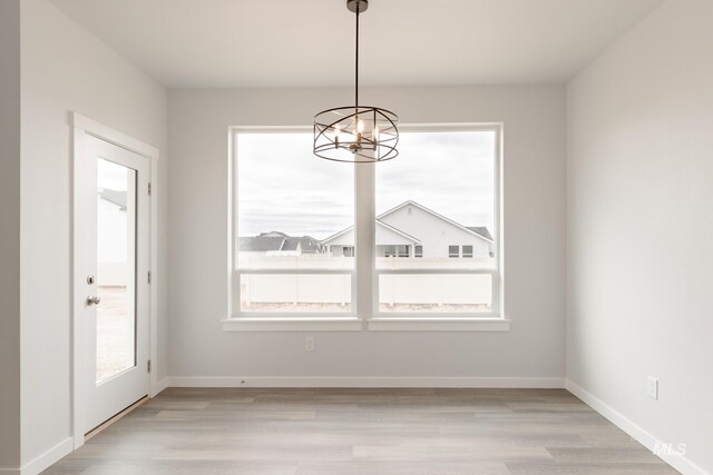 unfurnished living room with a healthy amount of sunlight, ceiling fan, and light hardwood / wood-style flooring