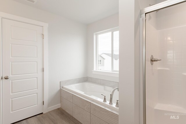 laundry area featuring electric dryer hookup, washer hookup, and light hardwood / wood-style flooring