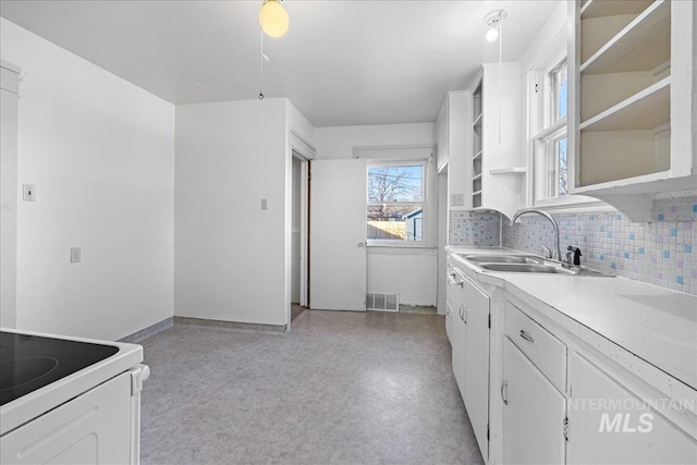 kitchen with white cabinetry, sink, tasteful backsplash, and white range with electric stovetop