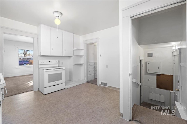 kitchen featuring white cabinetry, light colored carpet, and white electric stove