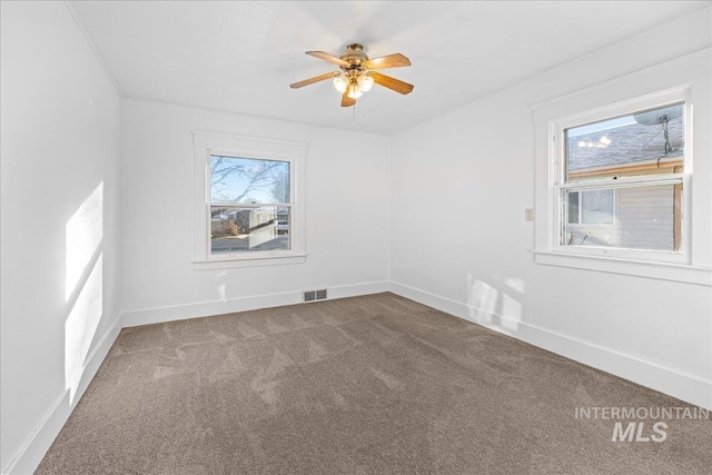 carpeted spare room featuring ceiling fan