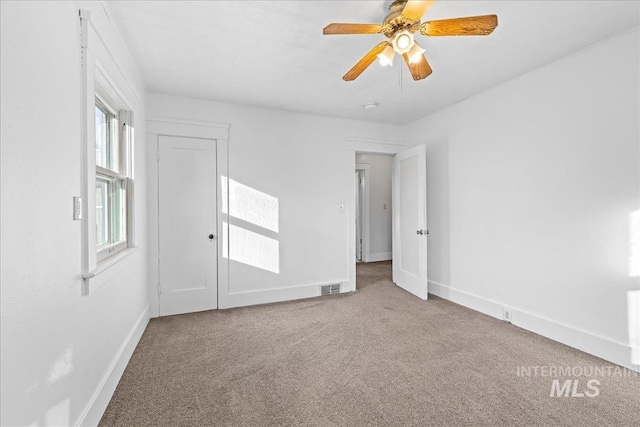 carpeted empty room with ceiling fan