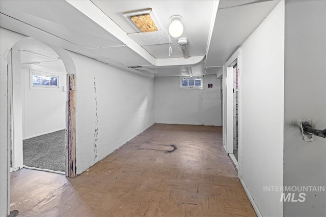 basement with plenty of natural light and parquet flooring