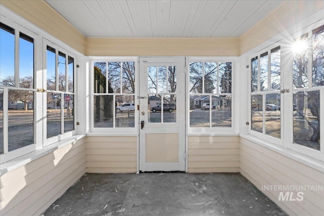 unfurnished sunroom with plenty of natural light and wooden ceiling