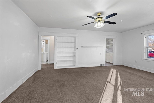 interior space with ceiling fan and dark colored carpet