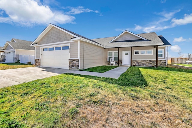 craftsman inspired home with a garage, a front lawn, and a porch