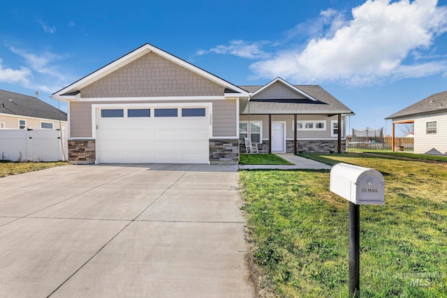 craftsman-style house featuring a front yard and a garage