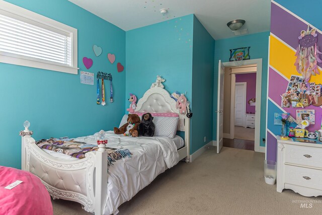 bedroom featuring carpet and baseboards