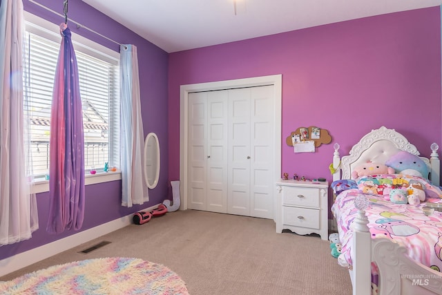 bedroom featuring carpet, visible vents, and a closet